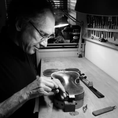 David Bonsey working hard on a violin repair project in his violin repair and restoration shop in New York NY